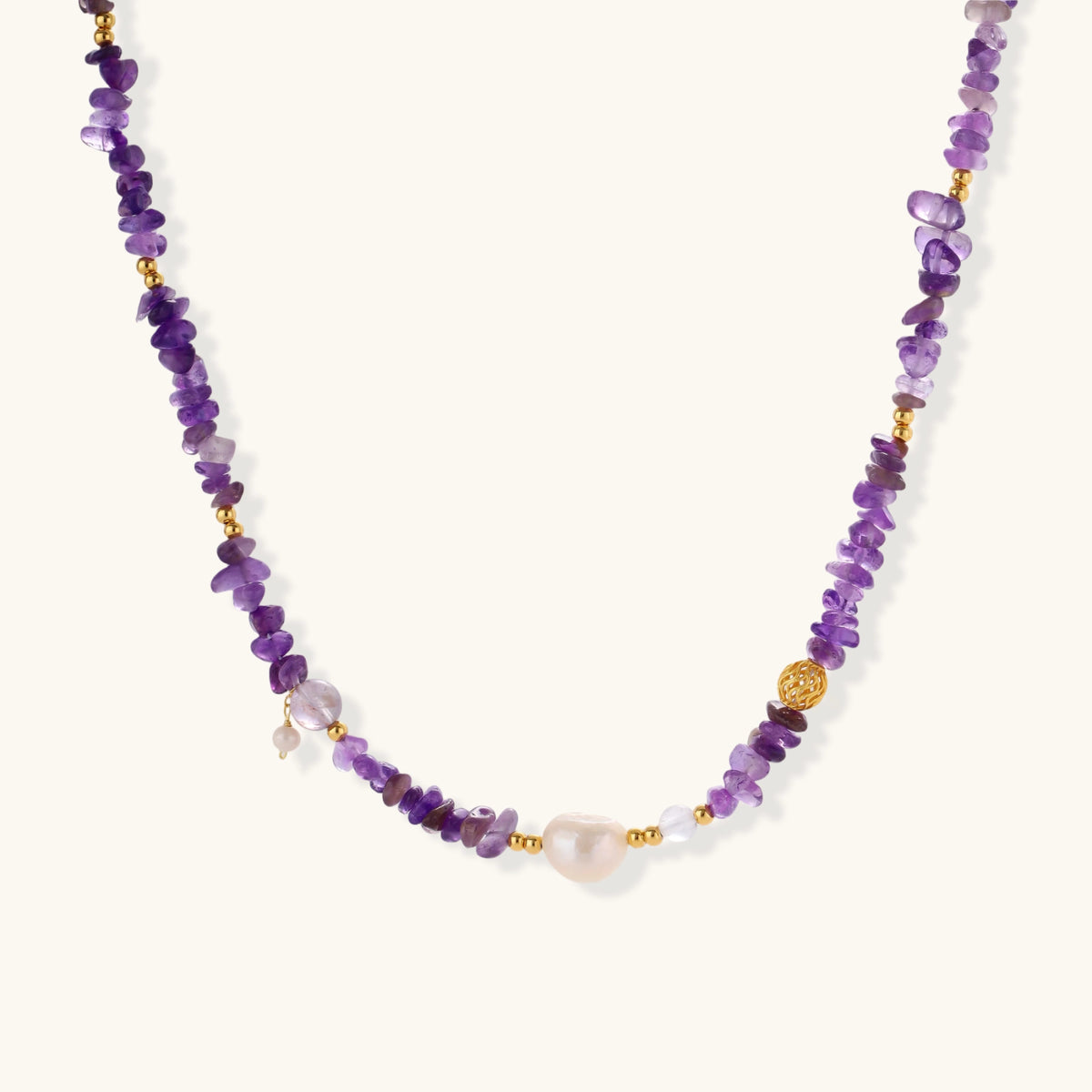 Beaded necklace with purple amethyst chips, freshwater pearls, and gold accents on white background.