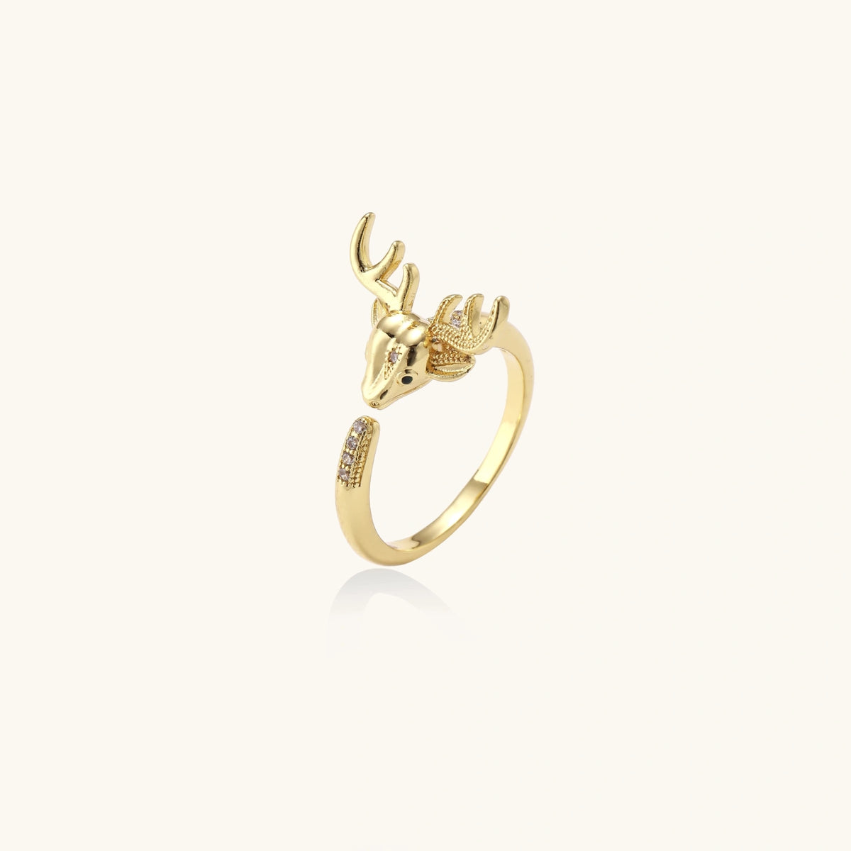 Gold-plated adjustable ring featuring 3D deer head with detailed antlers and cubic zirconia accents on cream background