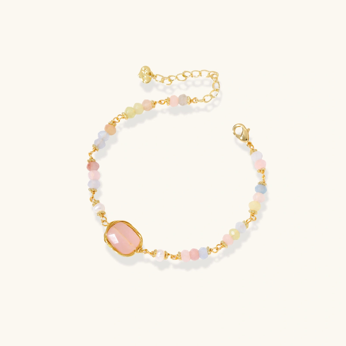 Delicate beaded bracelet with pastel rose quartz, pearls, and pink cushion-cut centerpiece in gold-plated setting