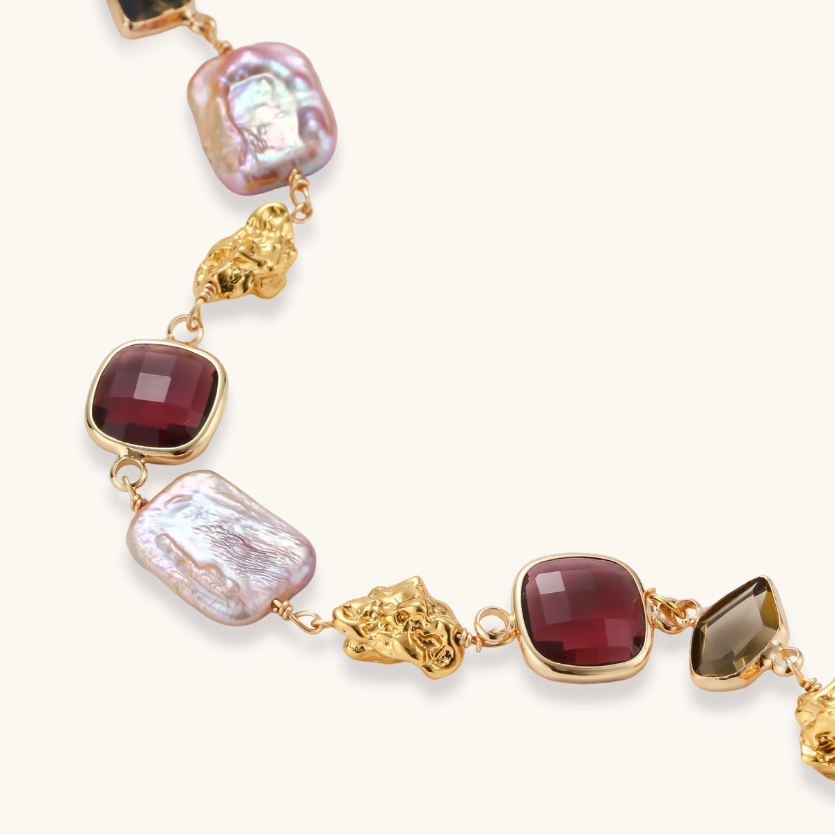 Gold plated toggle bracelet with baroque freshwater pearls, burgundy square stones, smoky brown stones and gold nugget links.